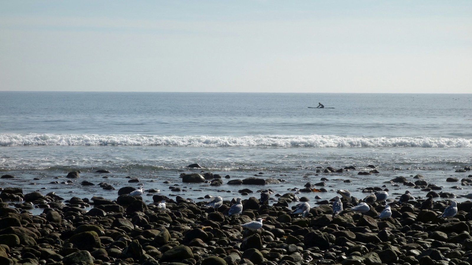a person riding a surfboard on a wave in the ocean
